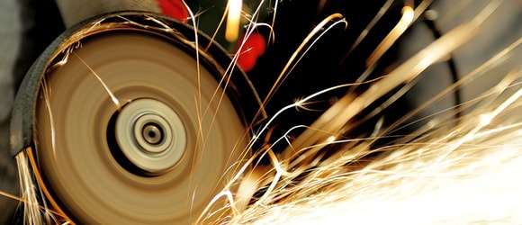 saw blade grinding with sparks shooting out of it